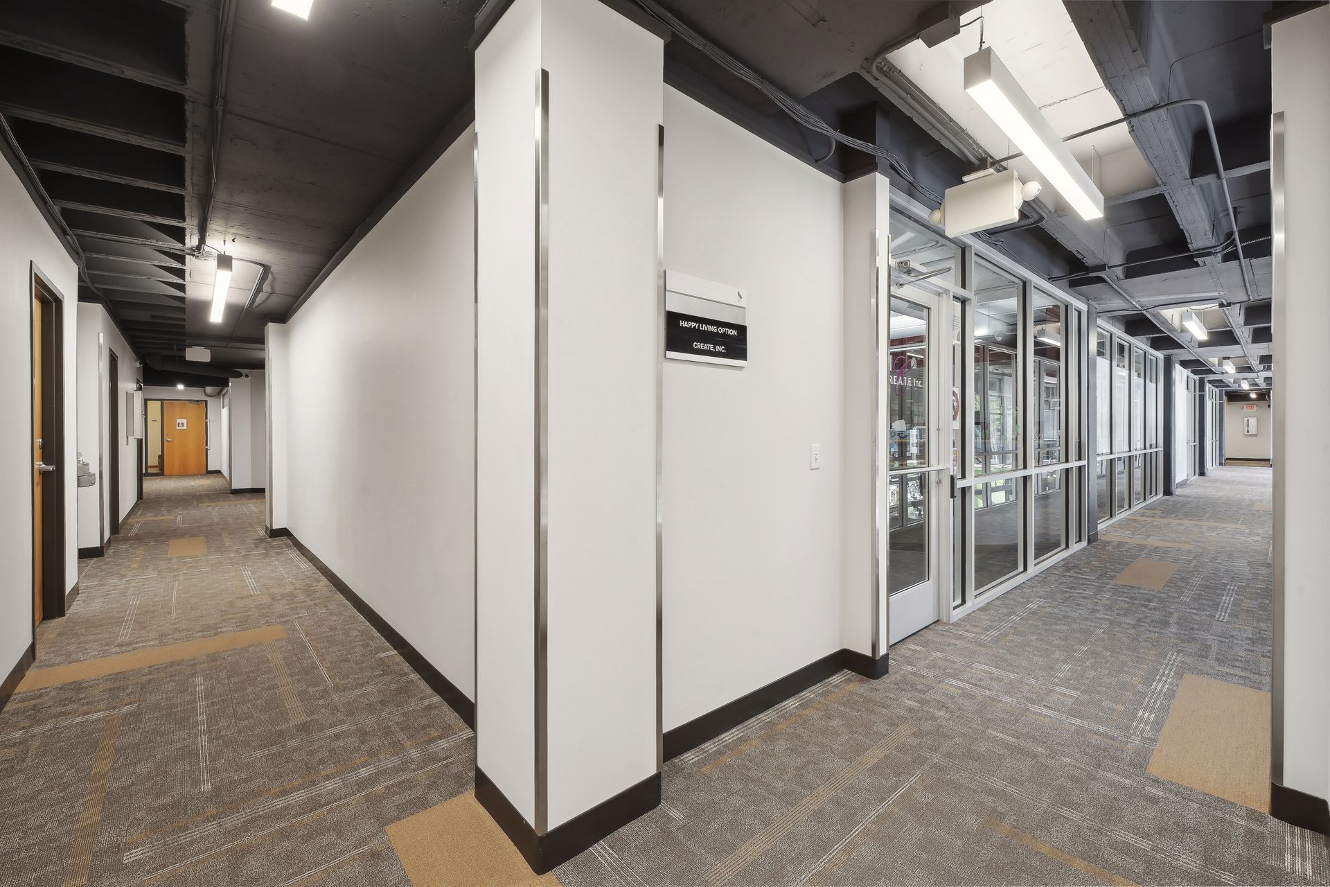 Upper-floor corridor with glazed office fronts