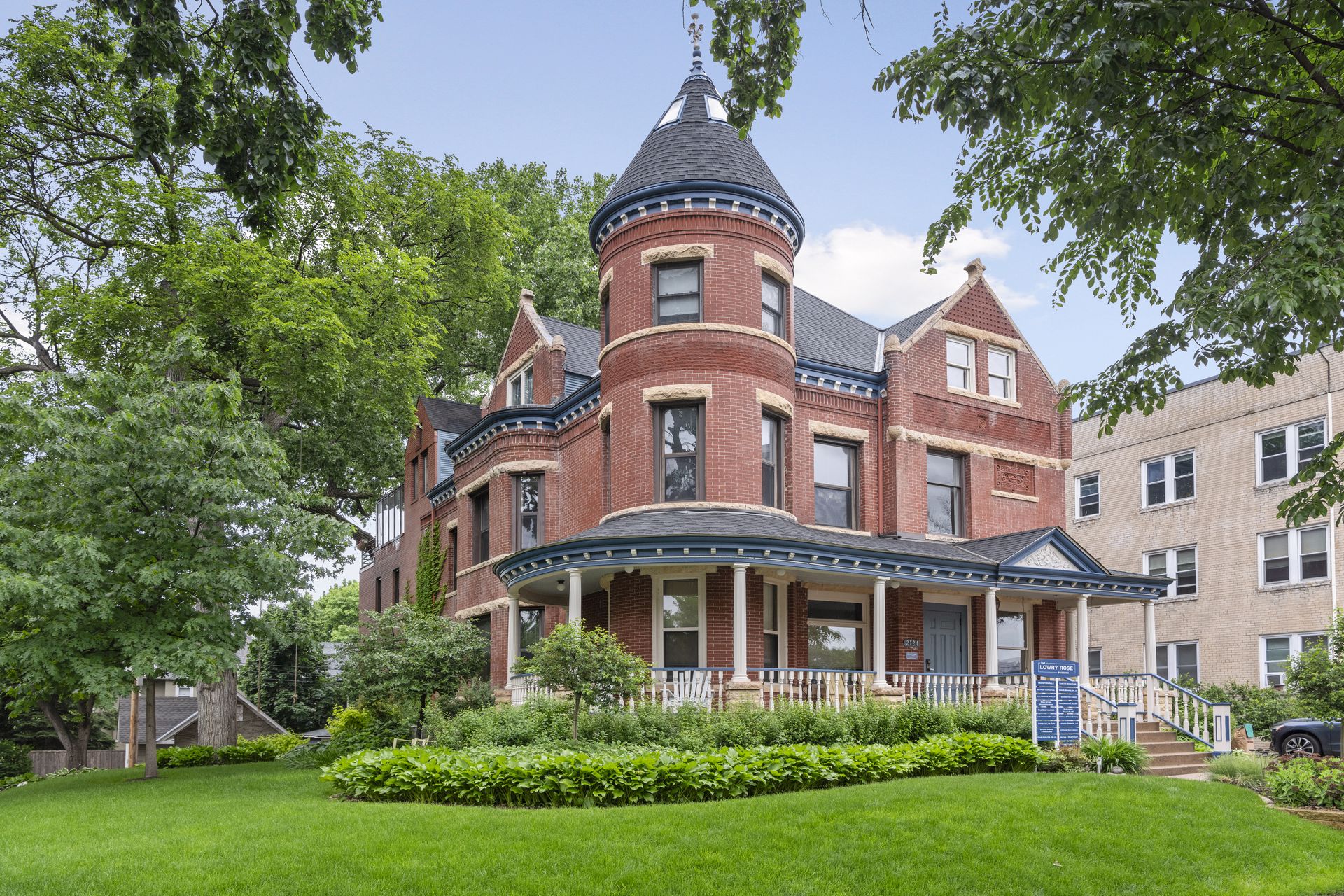 The Lowry Rose Building at 2124 Dupont Avenue South, Minneapolis, showing its round brick turret and wraparound porch