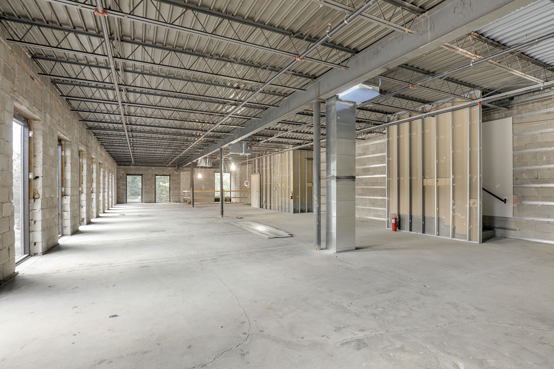 Construction shell with concrete block walls, steel bar joists and metal stud partitions