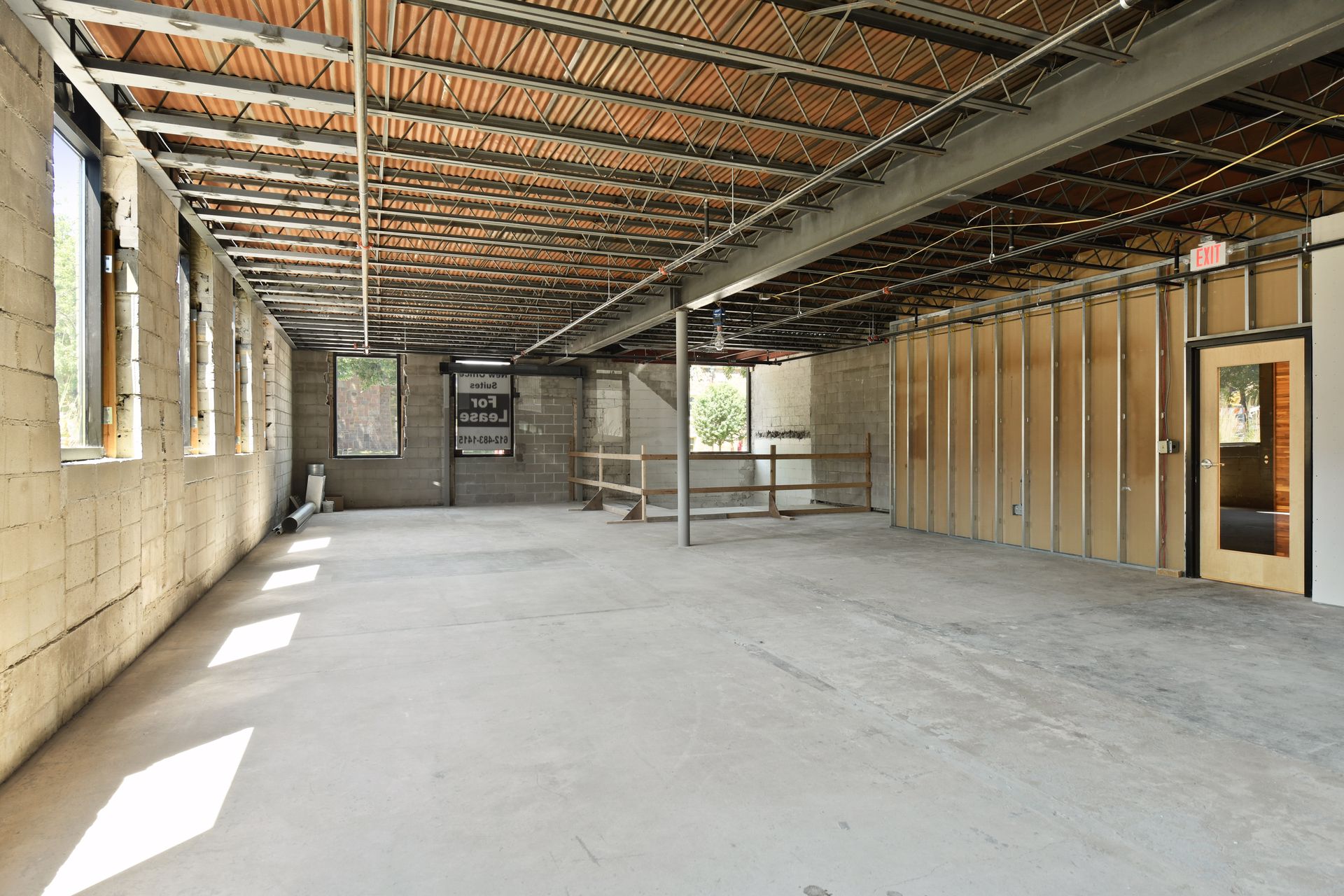 Construction shell with concrete block walls, a corrugated deck and metal stud partitions