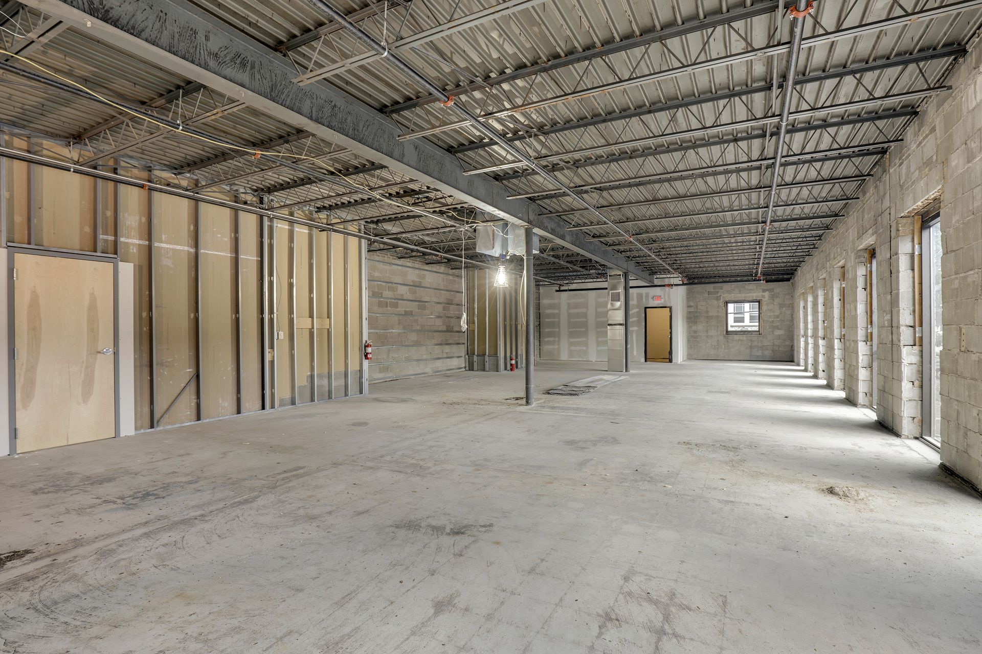 Construction shell with concrete block walls, steel bar joists and stud framing