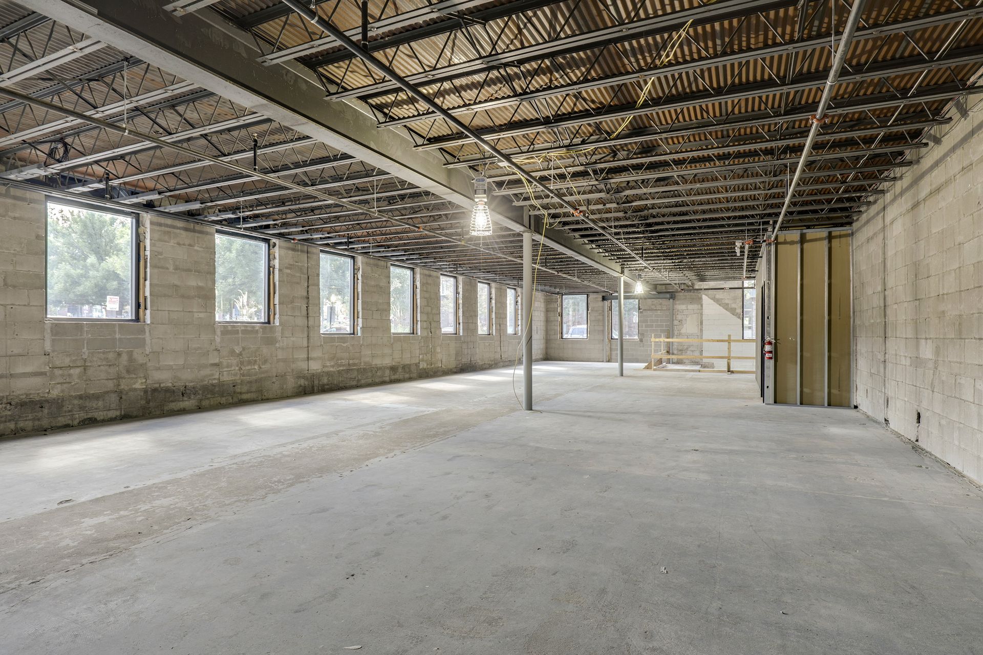 Construction shell with concrete block walls and exposed steel bar joists