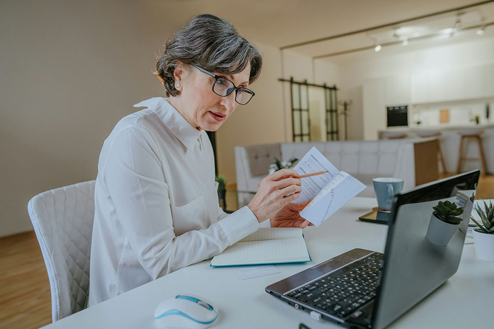 Mature learner reviewing course notes at a desk
