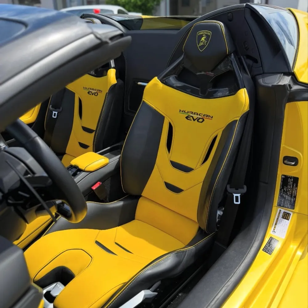 Yellow and black sport seats with Huracán EVO stitching and Lamborghini crest