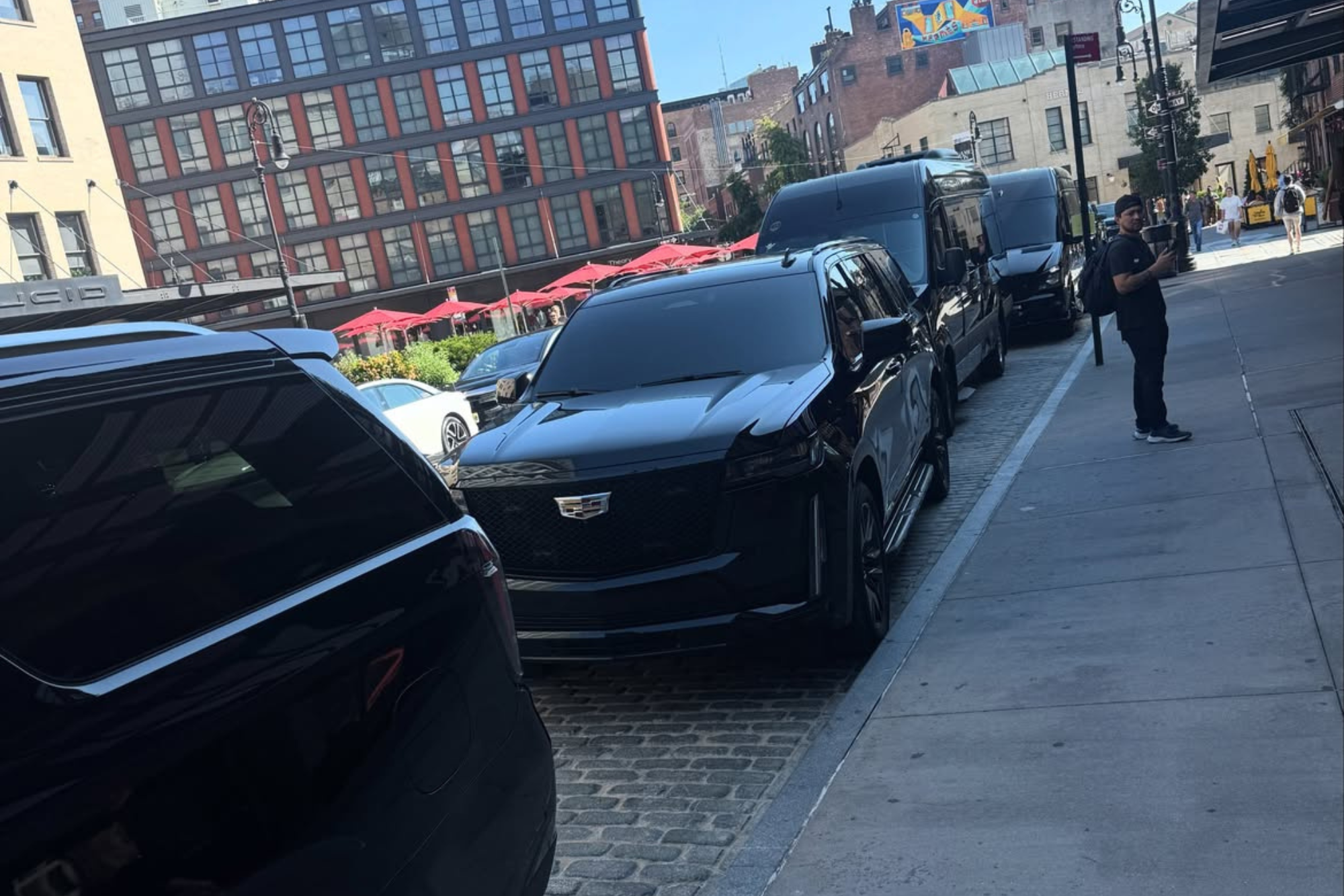 all black out suvs pulling up to an event