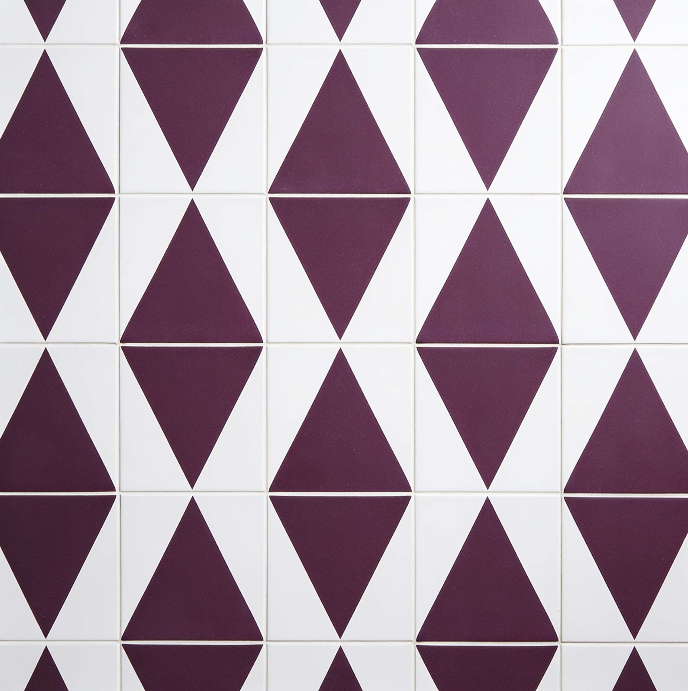 Wall tiles with a geometric pattern of purple diamond shapes arranged vertically on a white background.