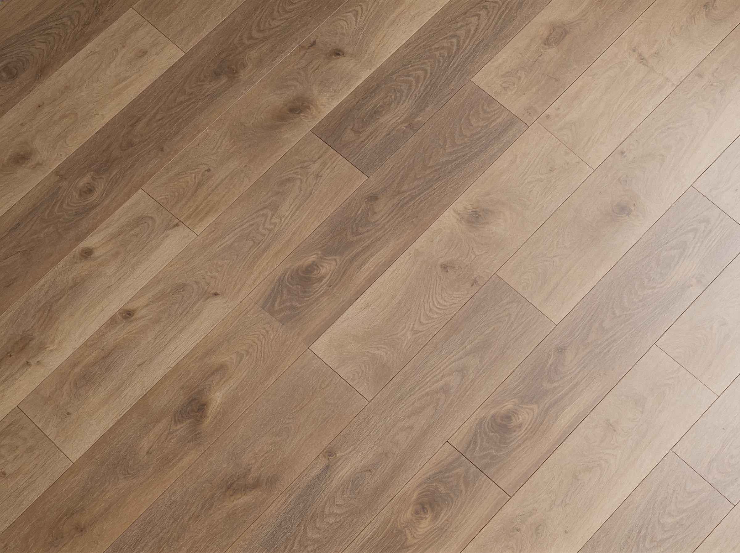 Natural oak hardwood flooring with a mix of medium and light brown planks featuring visible wood grain and knots in a staggered layout.