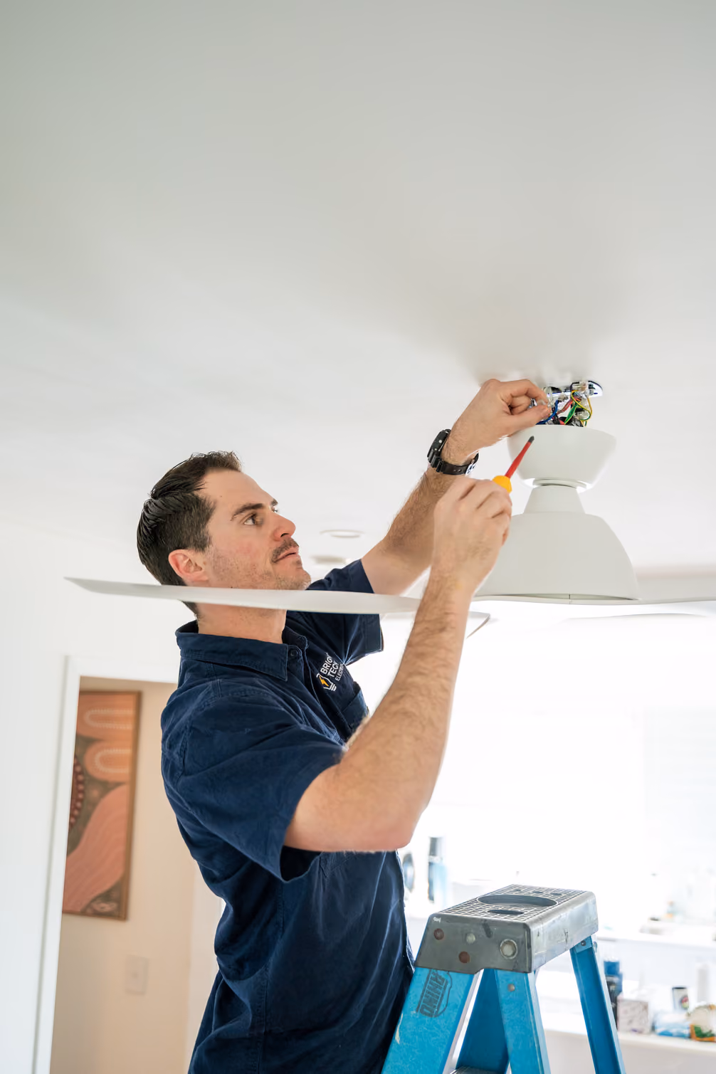 Electrician installing lighting and ceiling fans in Brisbane