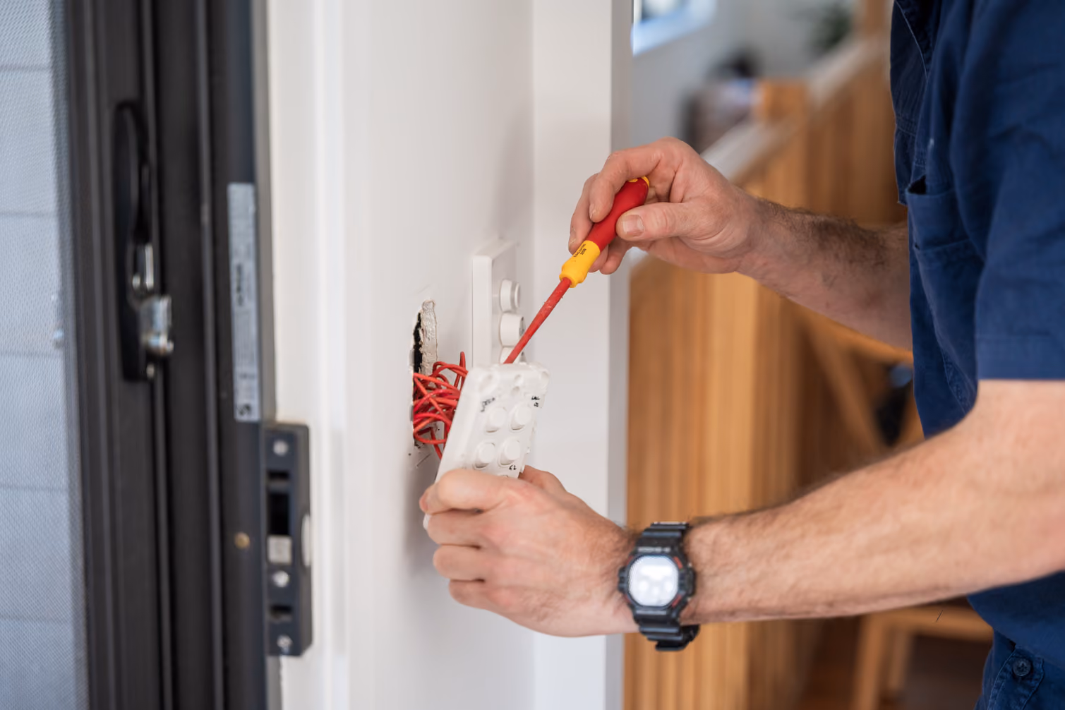 Electrician performing electrical safety inspection and repairs