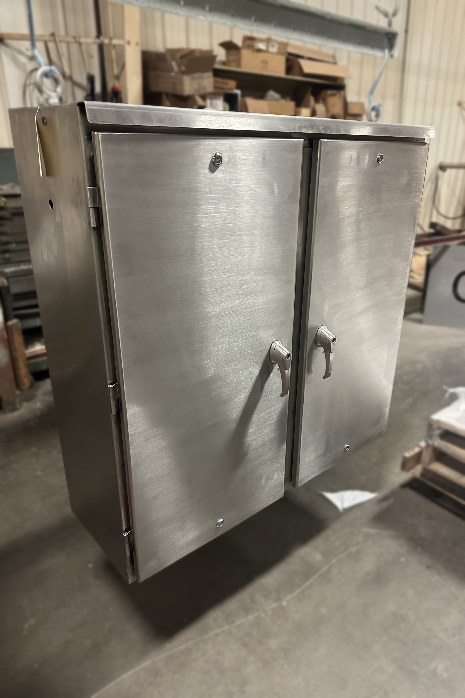Stainless steel double-door enclosure fabricated by Tri-Fab