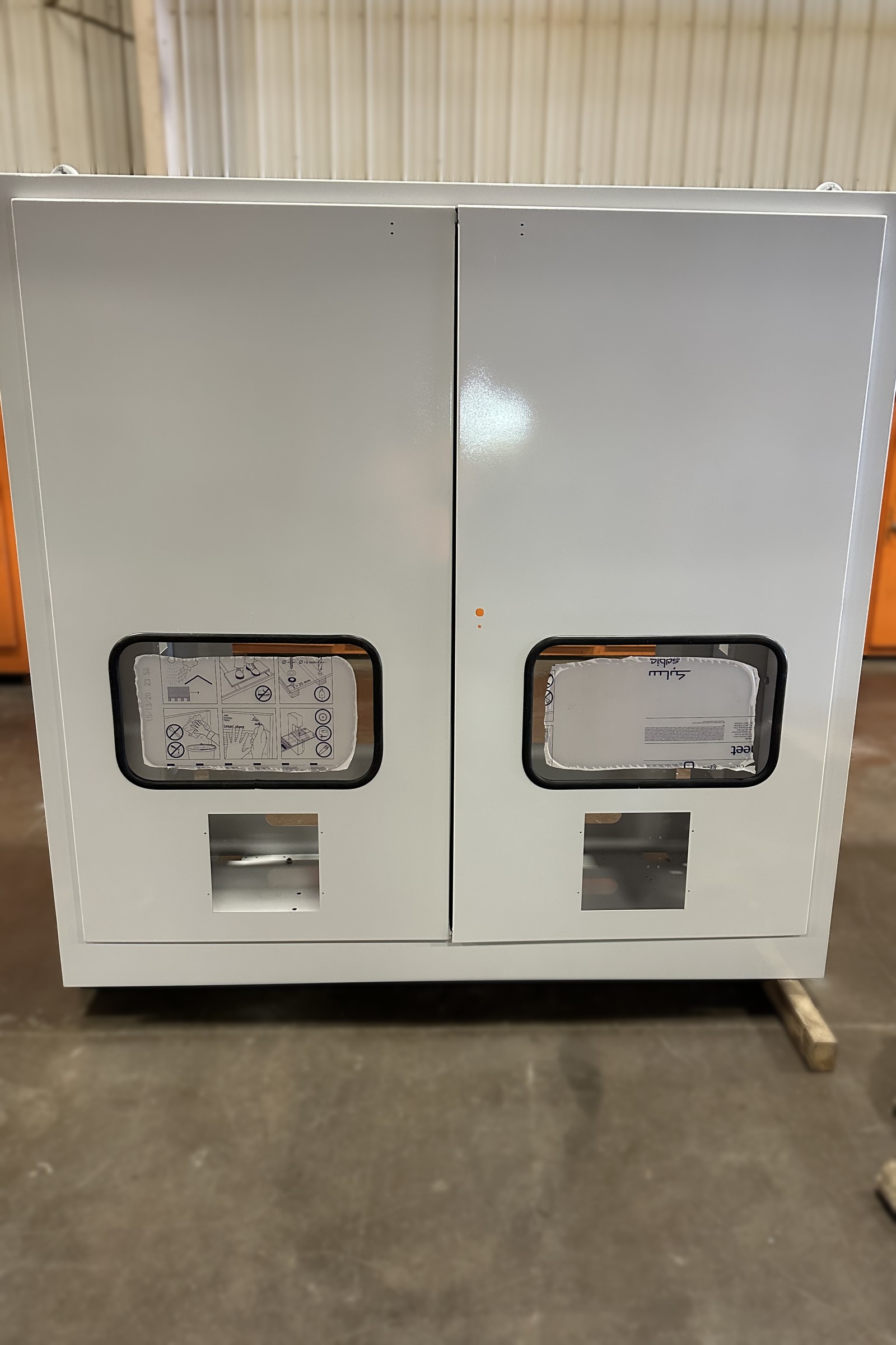 White painted double-door cabinet with viewing windows.