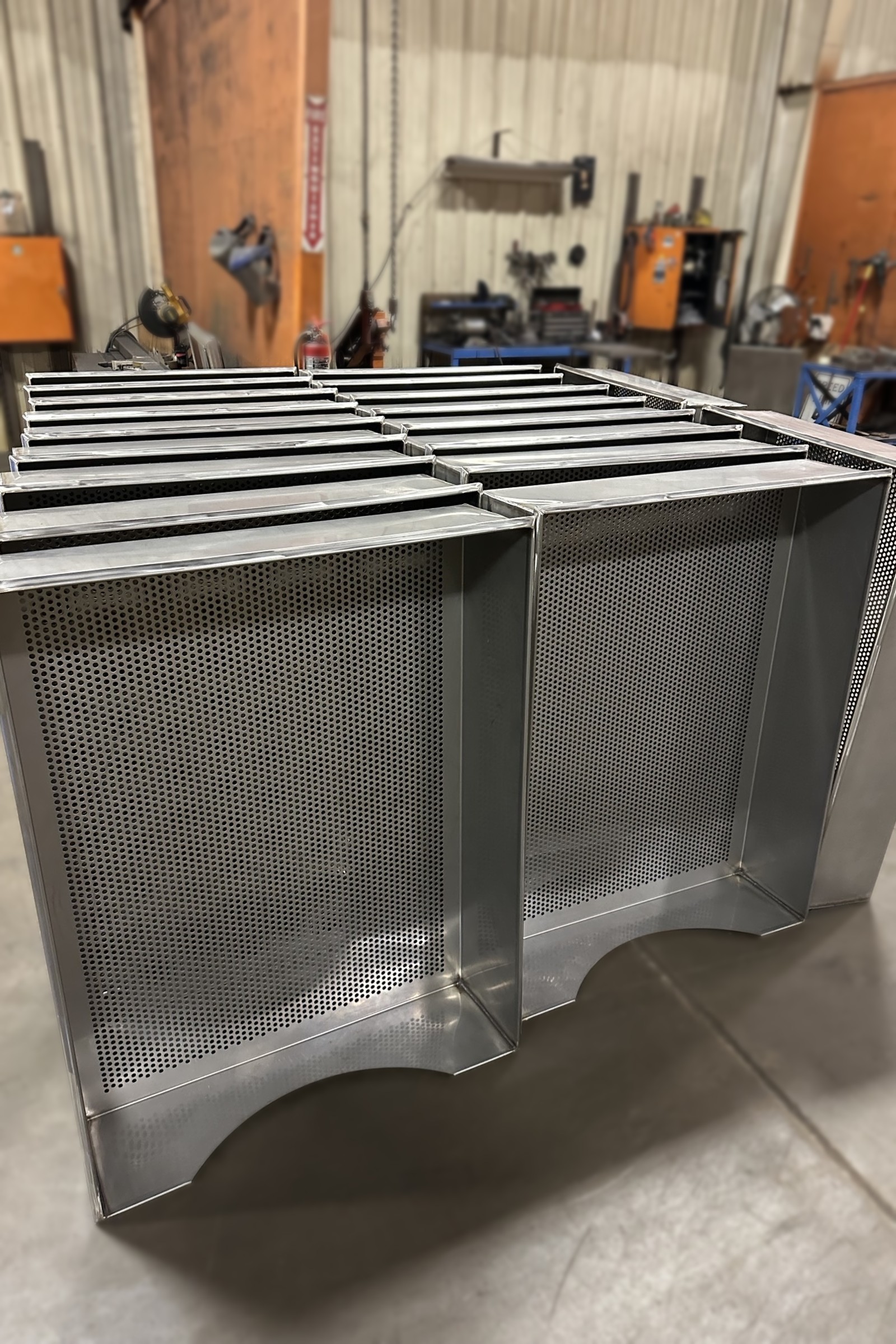 Two fabricated enclosures with perforated front panels.