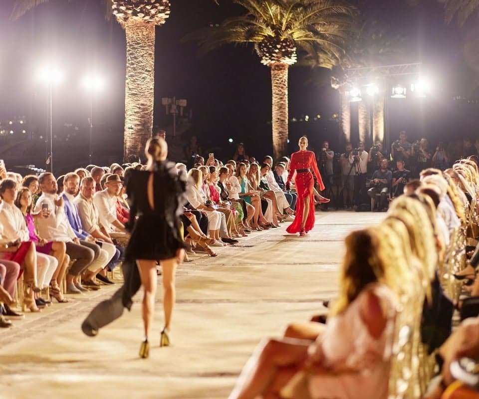 Elegant runway event showcasing high-end fashion in a tropical setting.