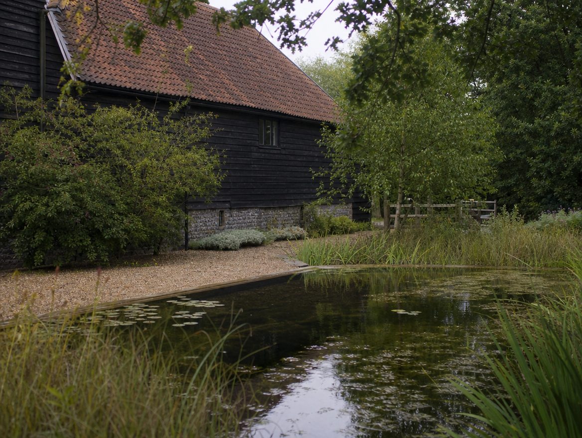 Swimming pool in the grounds of a period brick manor house
