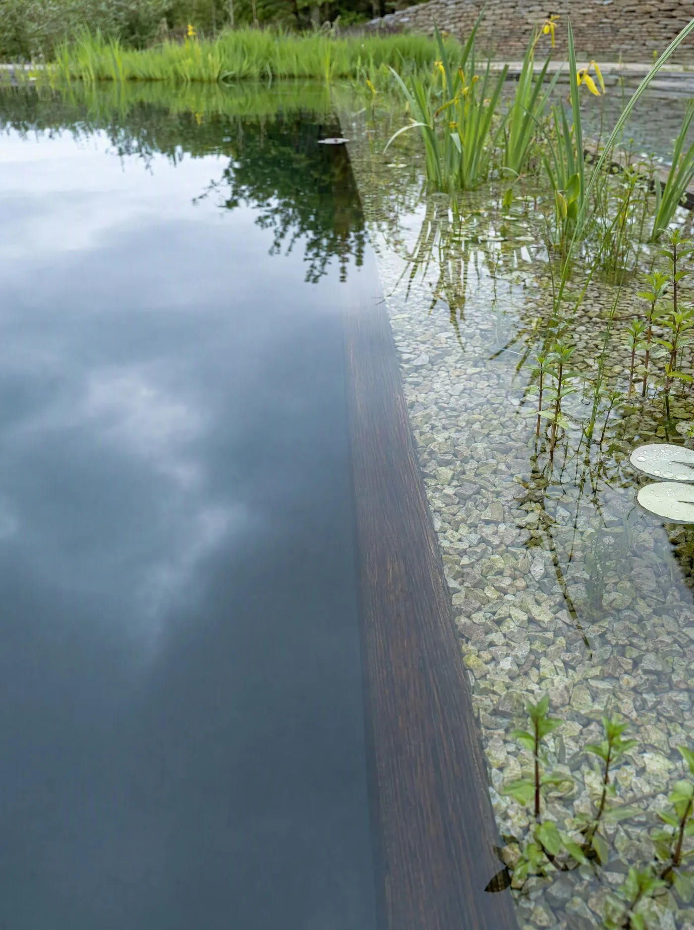 Design plans, drawings and a tape measure laid out on a garden table