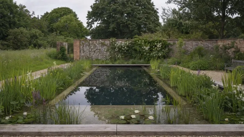 Design plans, drawings and a tape measure laid out on a garden table