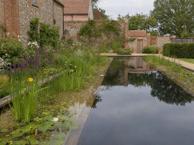 Swimming pool in the grounds of a period brick manor house