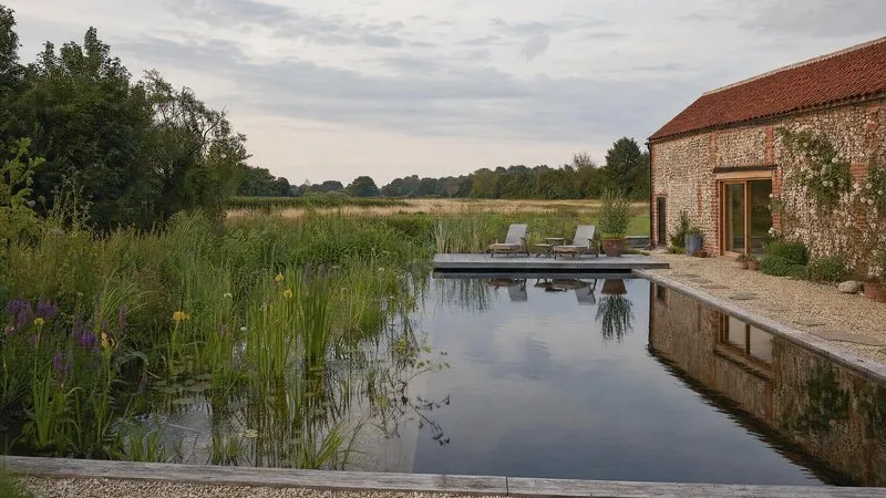 Swimming pond with an oak jetty at dawn