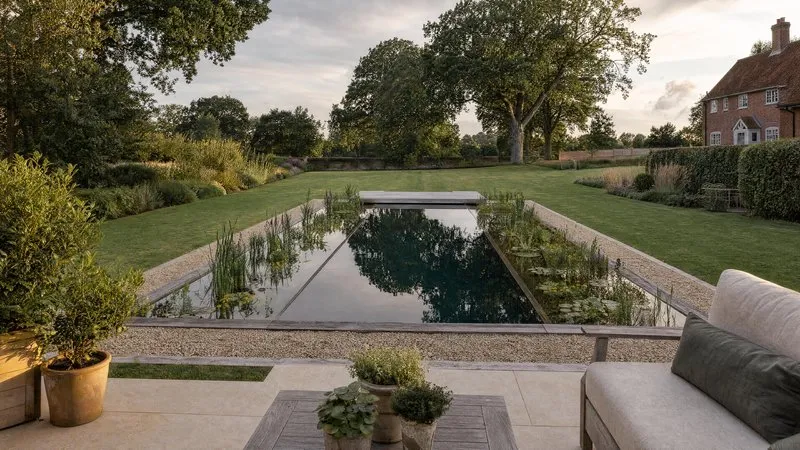 Design plans for a natural pool laid out on a table
