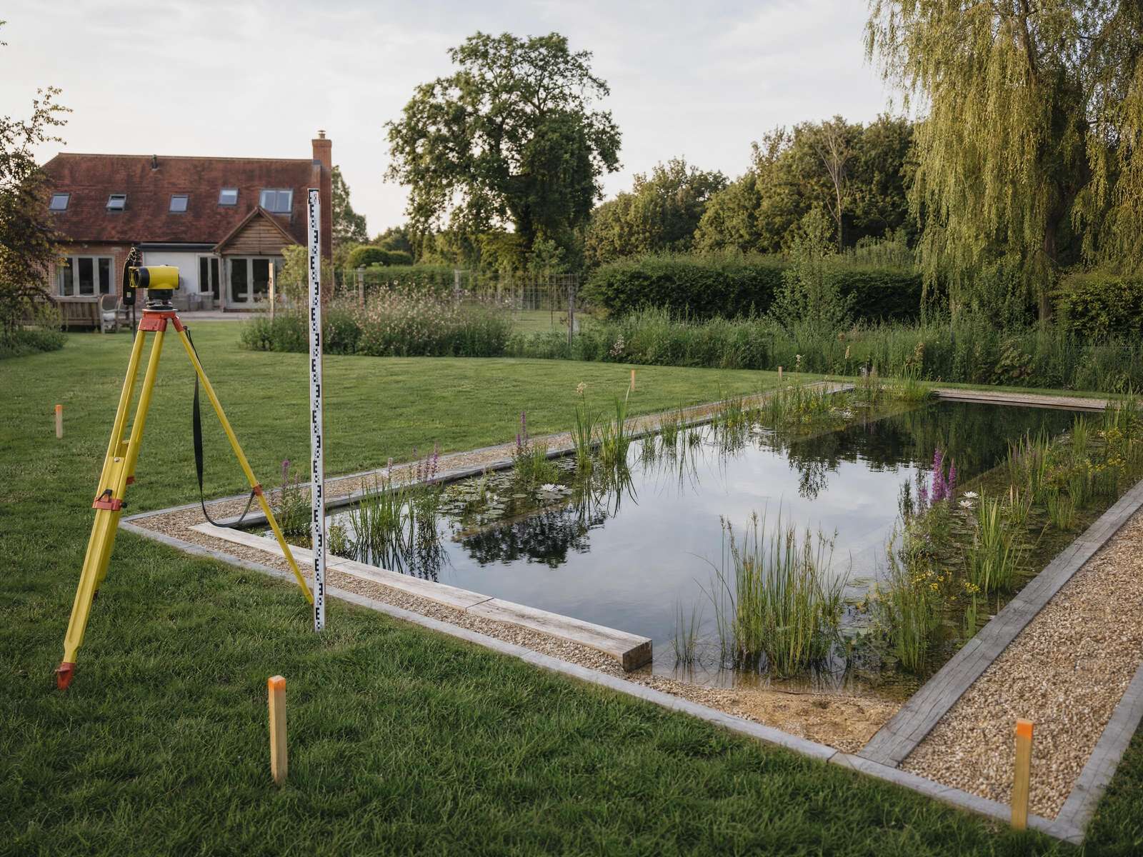 Natural pool designed to sit alongside a brick manor house