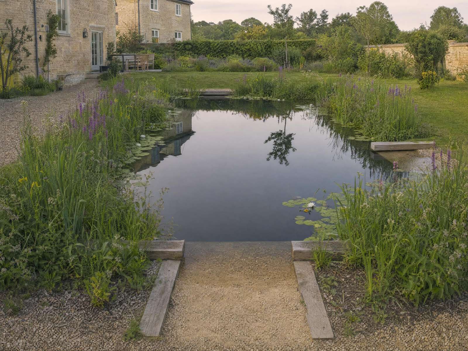 Natural swimming pool with cut stone coping