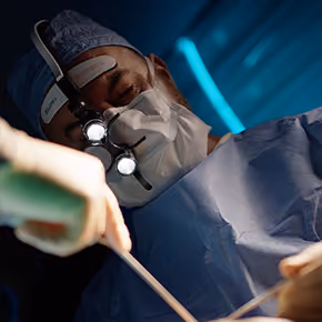Dr. Ghavami in surgical gown doing surgery in the operating room
