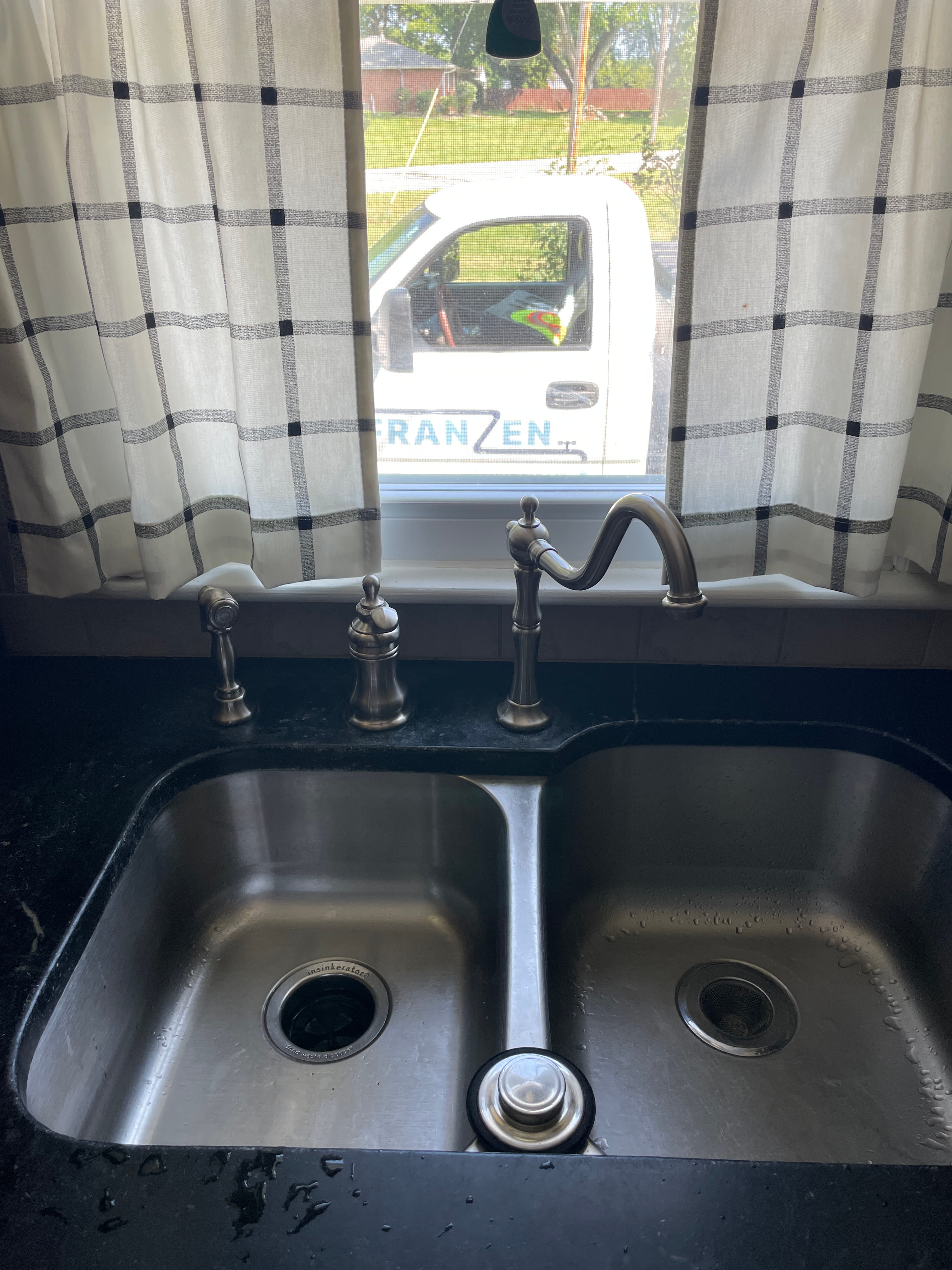 Franzen Plumbing Truck in window behind kitchen sink