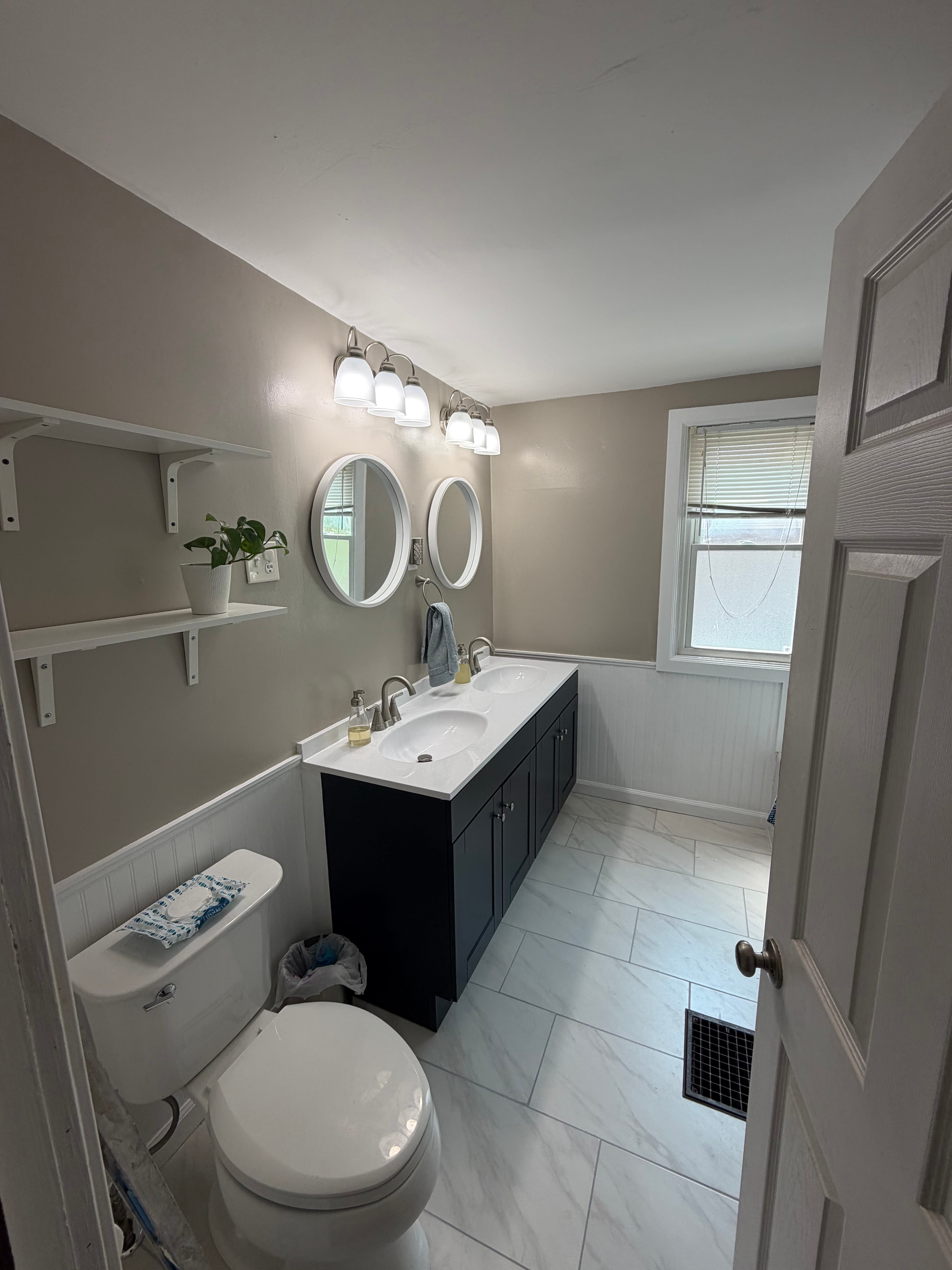 Updated dark blue vanity with new plumbing fixtures 