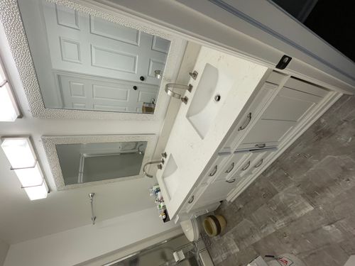 Updated bathroom double vanity with marble counter top and new faucets and fixtures