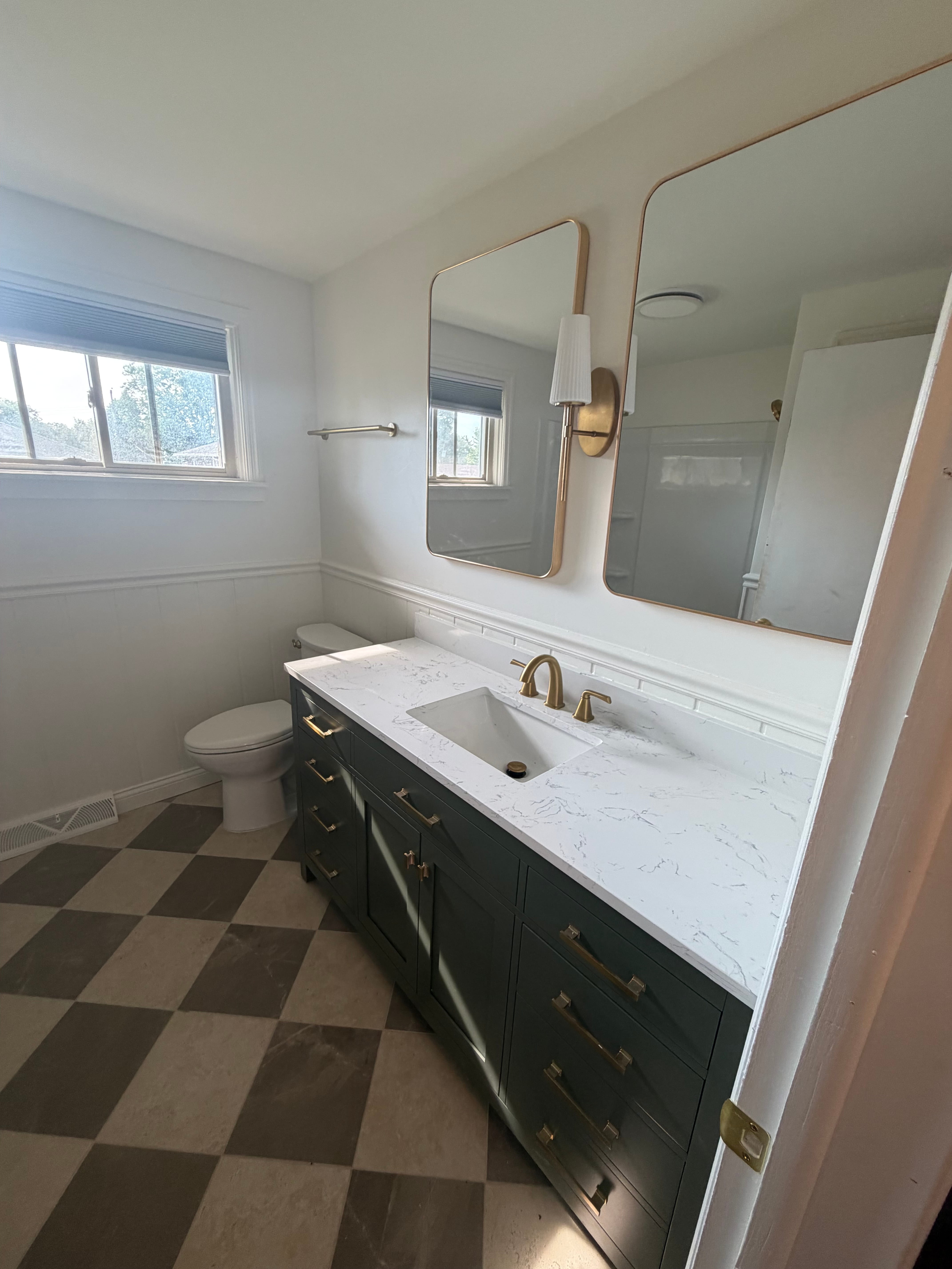 Bathroom renovation with new plumbing, fixtures and dark blue vanity
