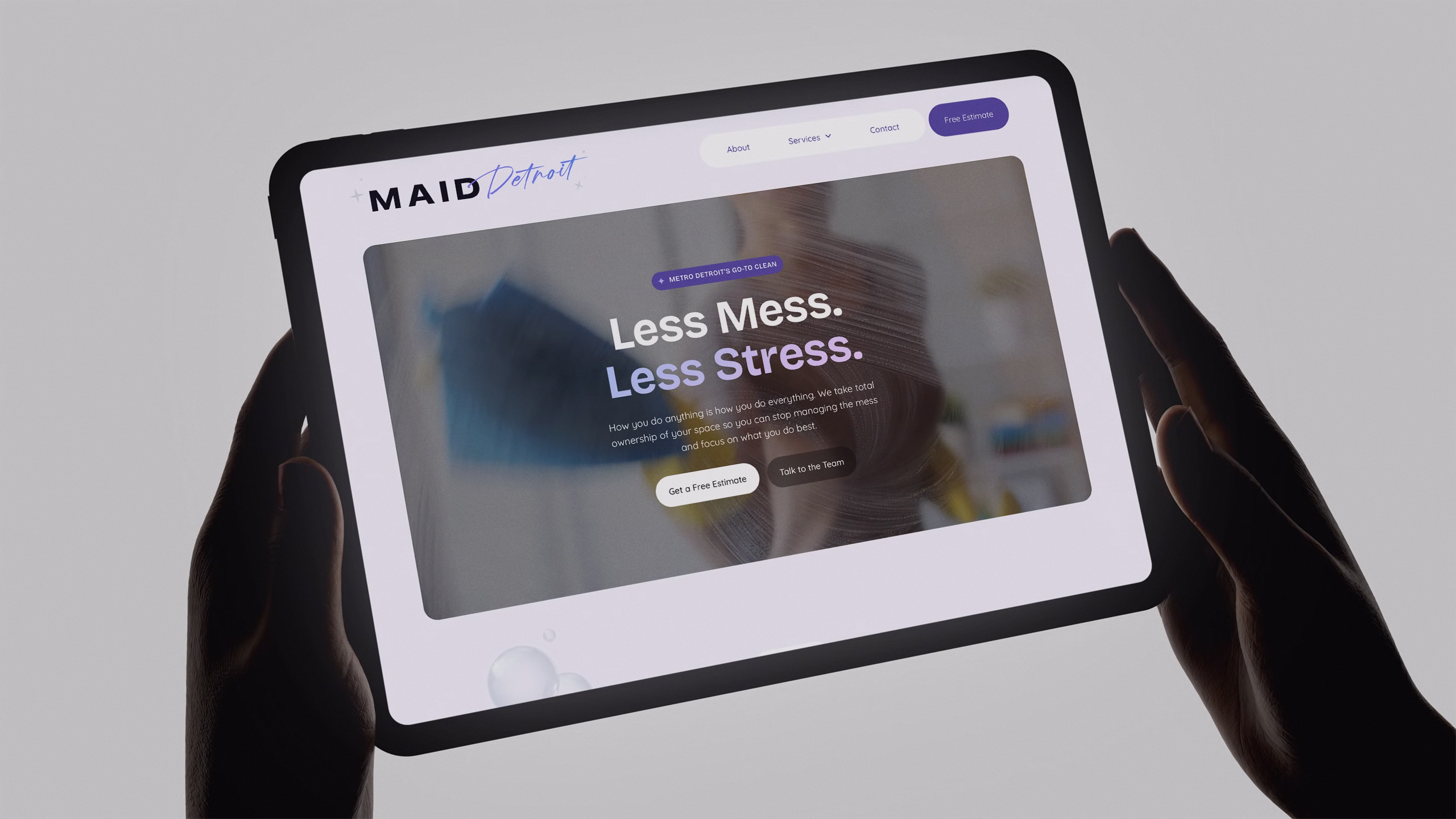 Tablet mockup of the MAID Detroit website homepage with "Less Mess. Less Stress." hero headline and call-to-action buttons