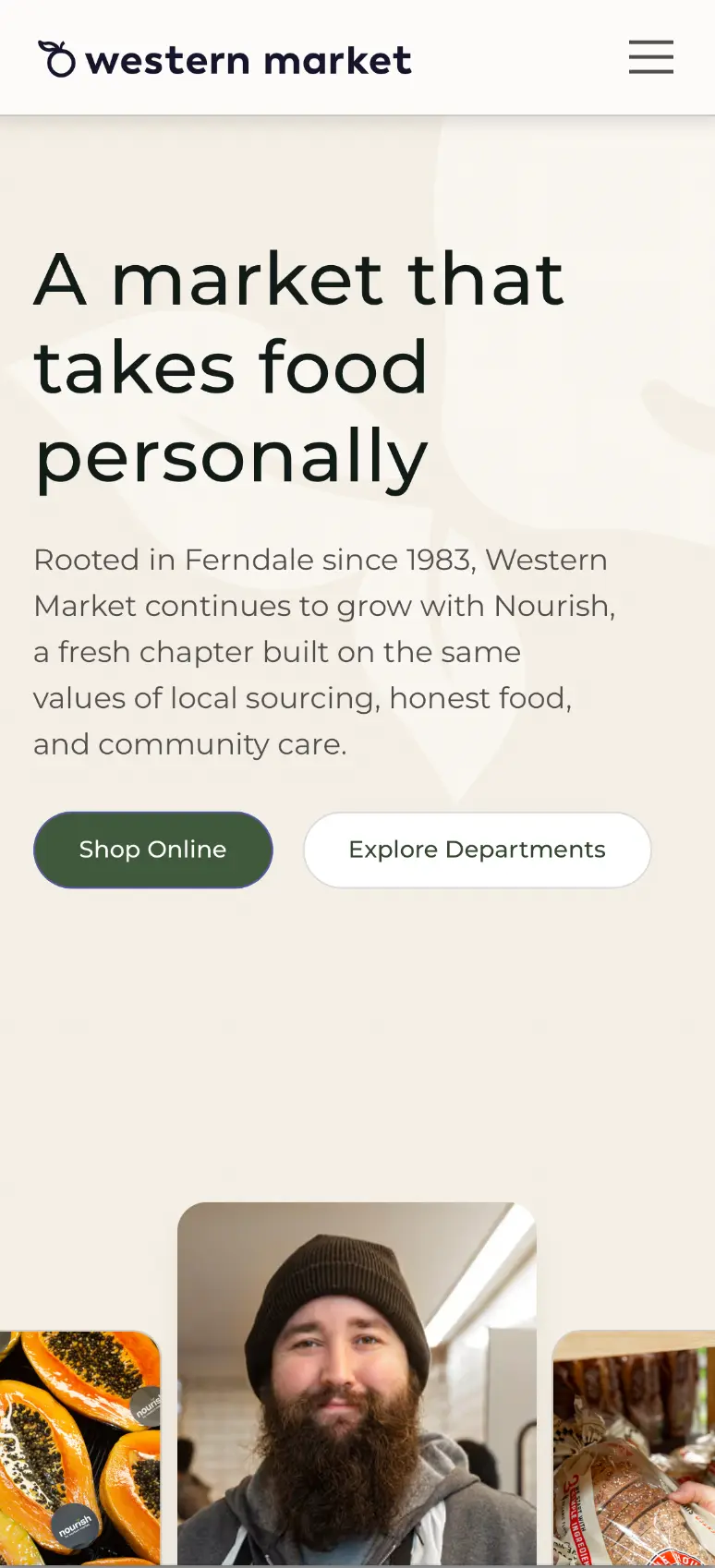 A market that takes food personally," a description of the store's Ferndale roots and its Nourish rebrand, "Shop Online" and "Explore Departments" buttons, and a row of photos featuring papayas, a bearded staff member, and fresh bread.