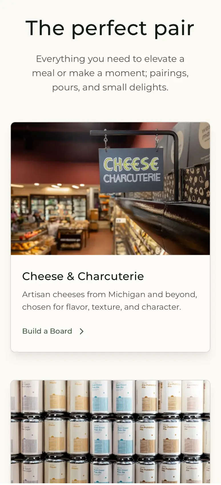 Western Market page section titled "The perfect pair," introducing pairings and small delights, with a photo of the in-store Cheese & Charcuterie counter sign, a "Build a Board" link, and a row of canned beer/cider products below.