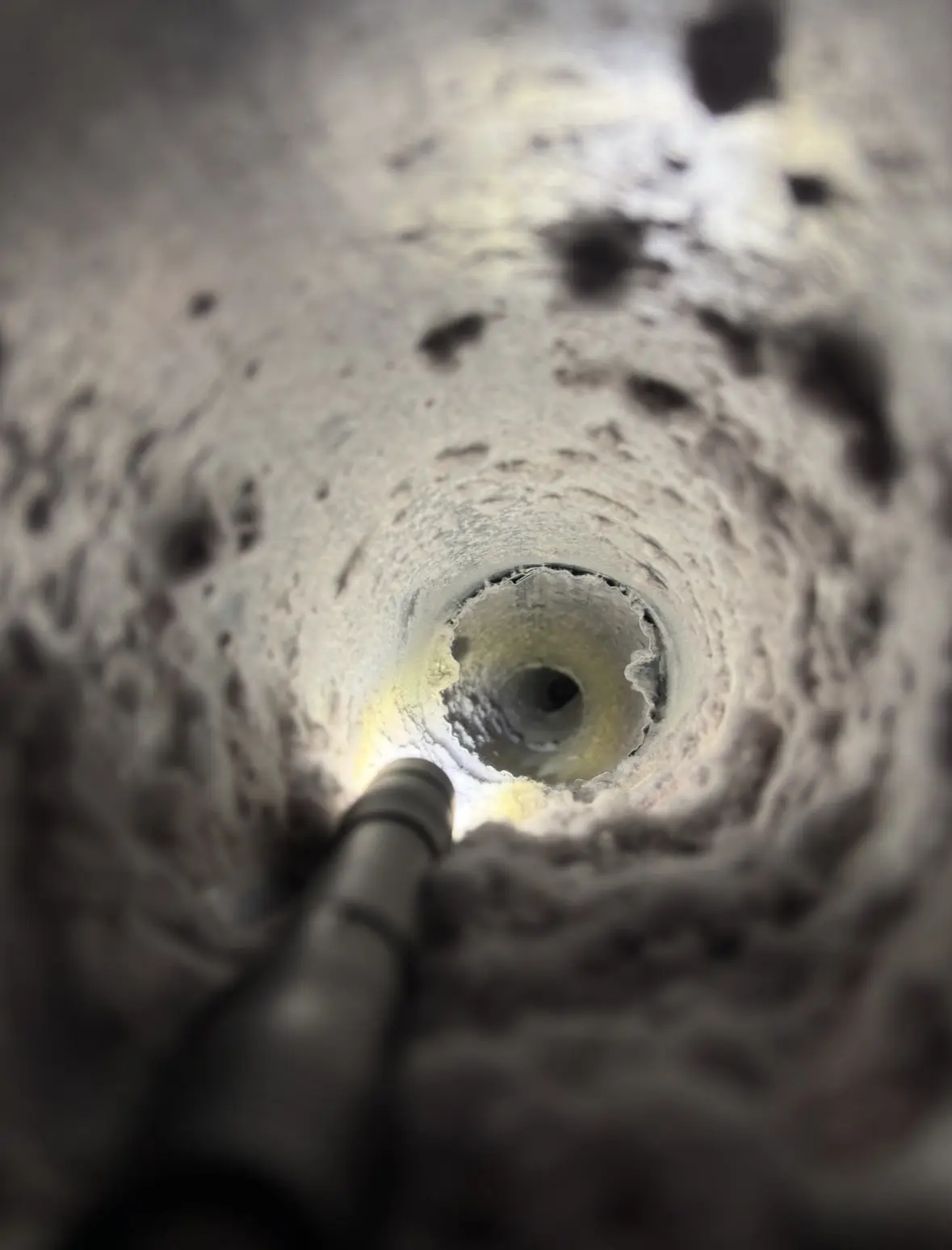 Heavy lint buildup inside a dryer vent before professional cleaning.