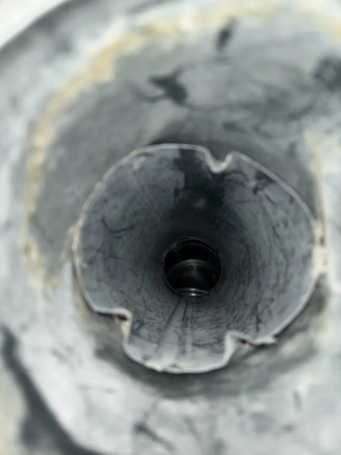 Interior inspection showing a clear metal dryer vent line after service.