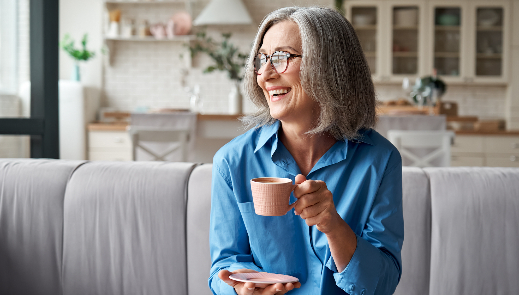 Woman on couch drinking coffee