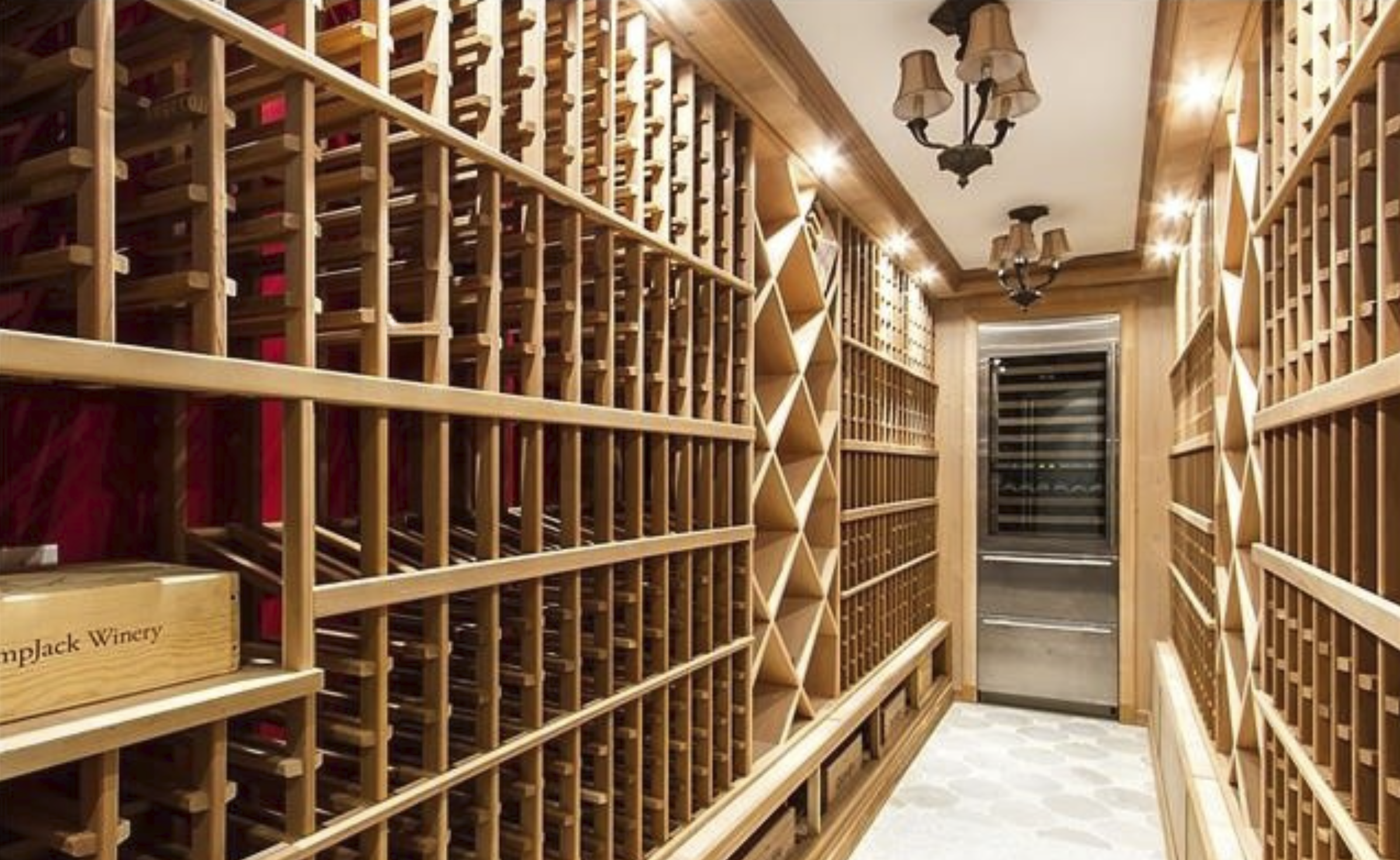 Wine room lined floor to ceiling with natural wood racks