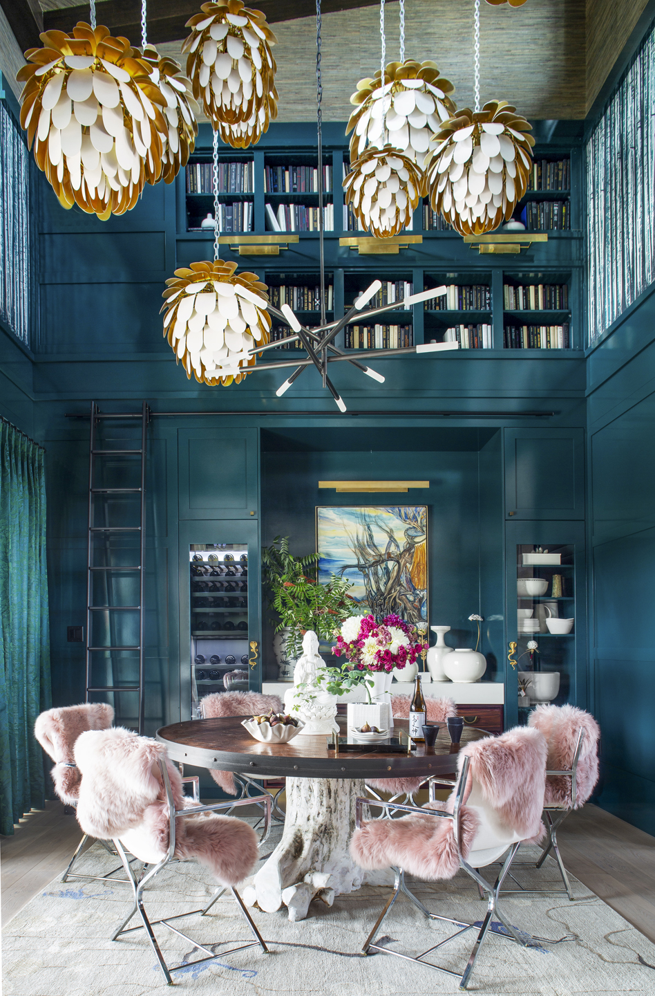 Teal dining room with pink velvet chairs and globe chandelier