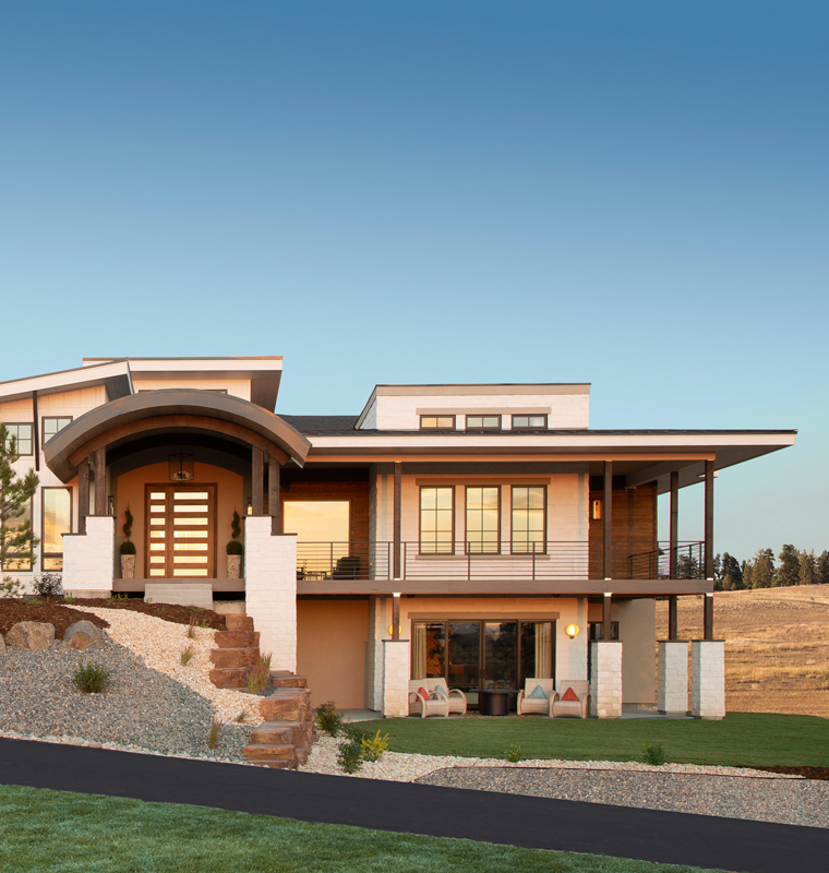 Walkout ranch custom home with arched entry and deep covered decks