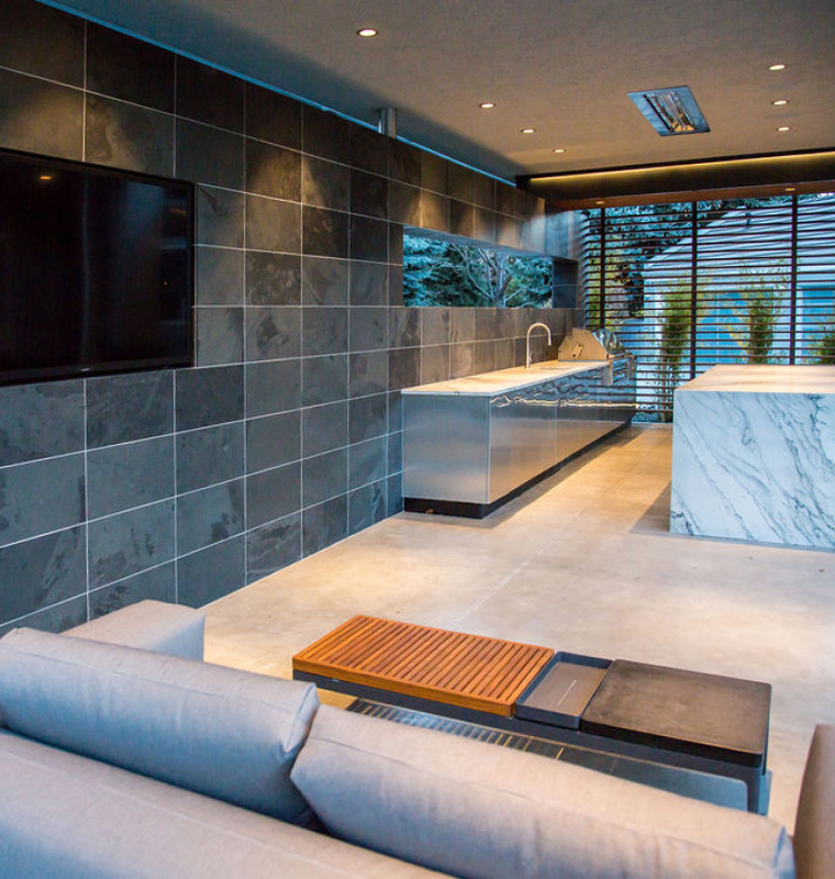 Modern living room with slate tile wall and marble kitchen island