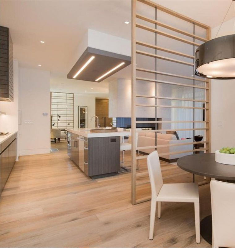 Open kitchen and dining area with a slatted screen and drum pendant light
