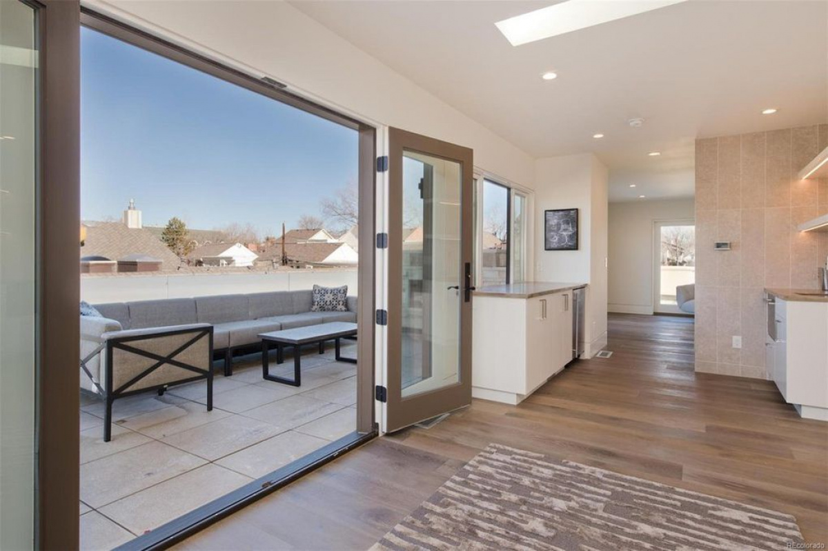 Wall of glass sliding doors opening to a covered patio