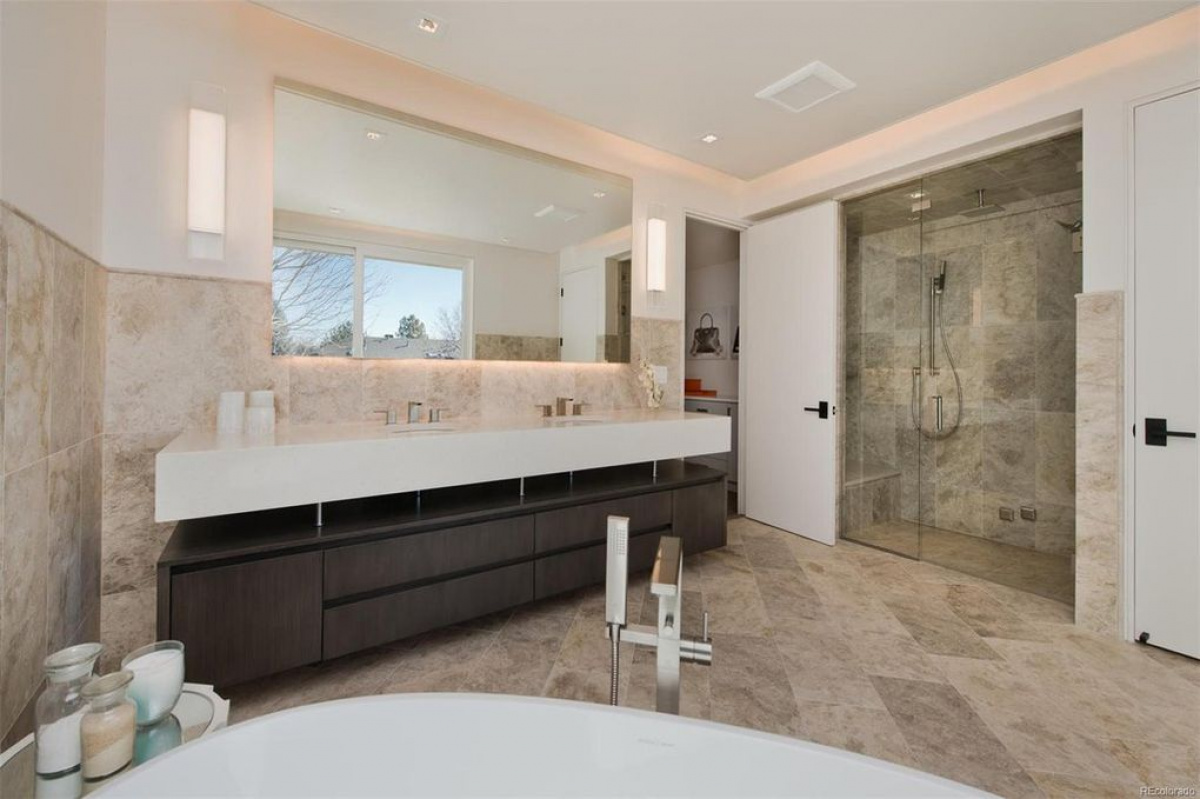 Primary bathroom with double floating vanity and stone shower wall