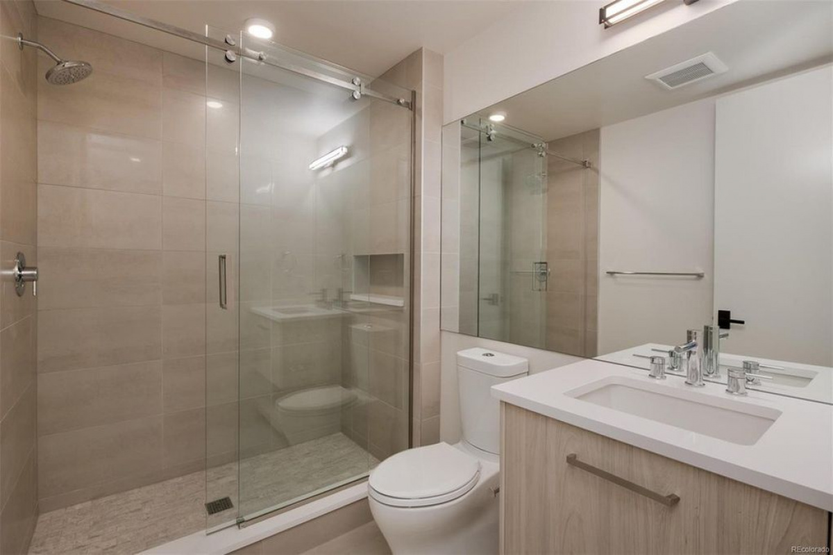 Bathroom with frameless glass shower and floating wood vanity