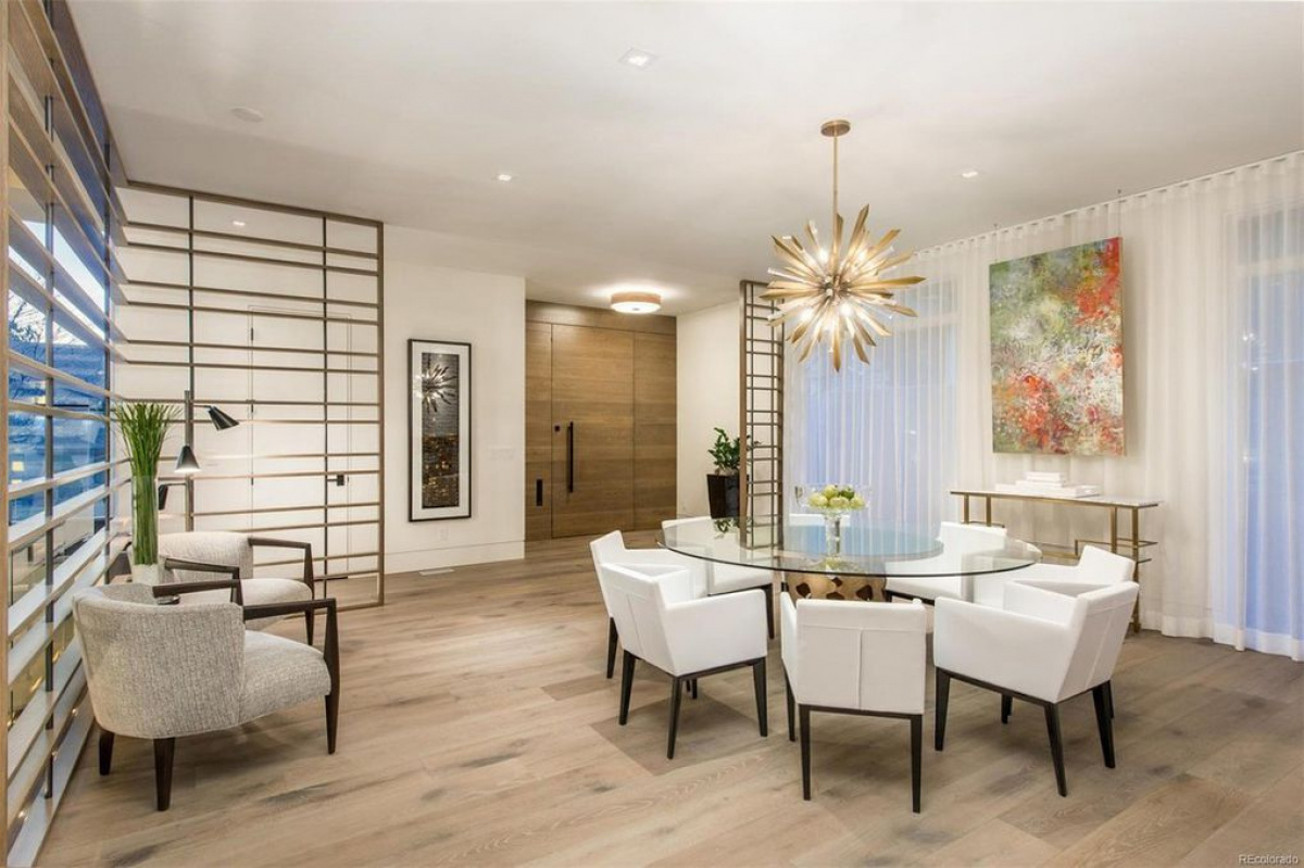 Dining room with sputnik chandelier and slatted stair screen