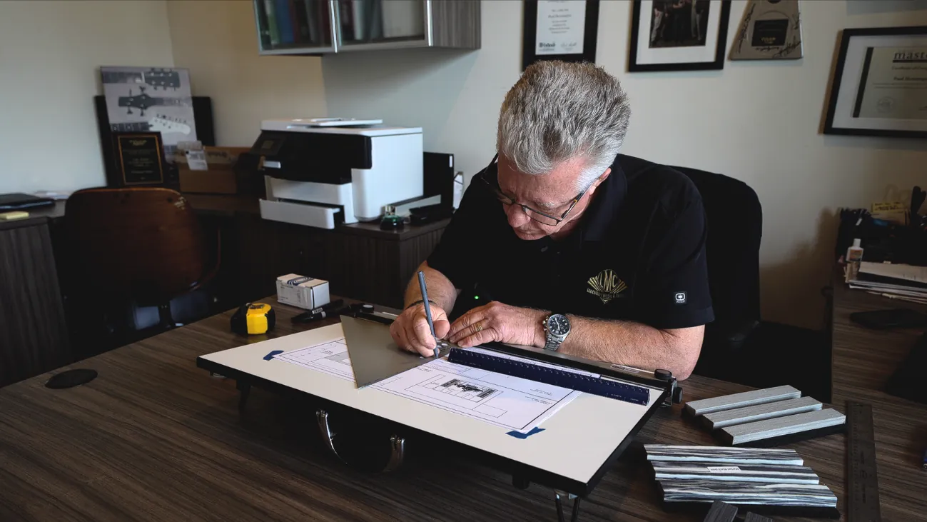 Paul Henningsen drafting a home cinema design at his board at LMC Home Entertainment