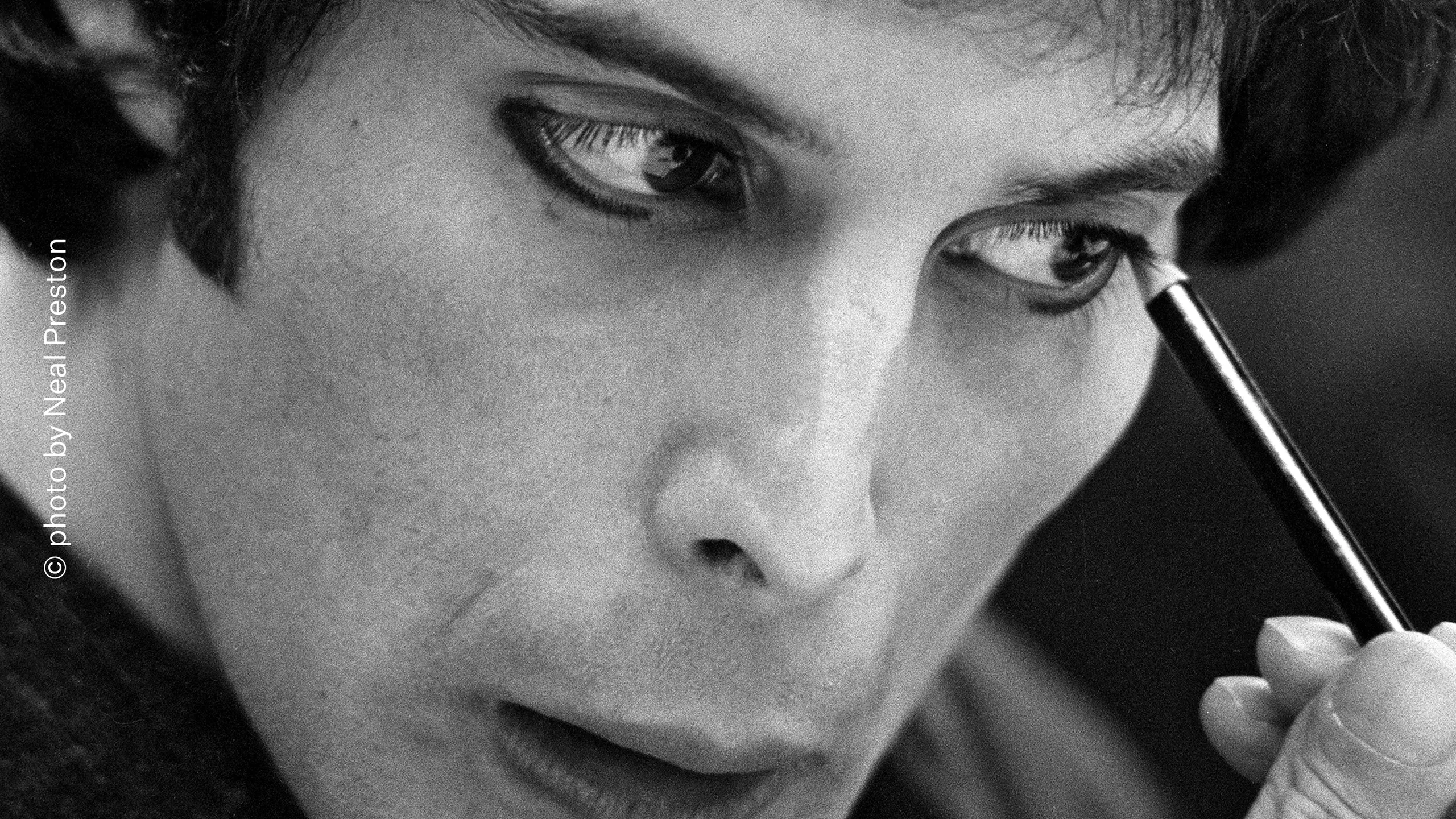 Freddie Mercury applying makeup backstage in 1980, photographed by Neal Preston
