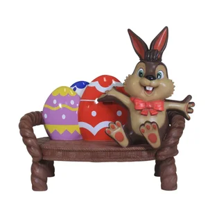 Decorative Easter bench with a smiling bunny and two colorful Easter eggs.