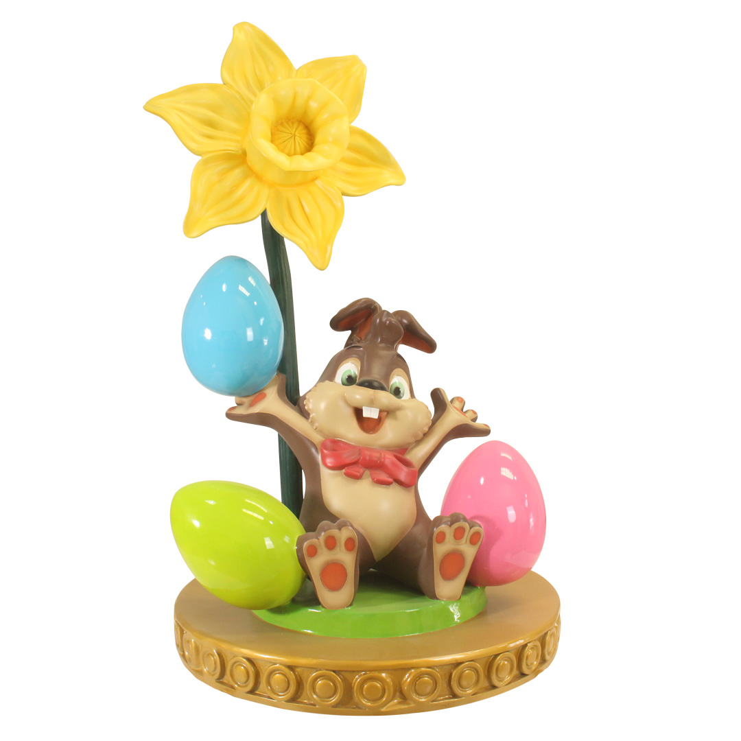 Easter decoration with a happy bunny, colorful eggs, and a large yellow daffodil flower.