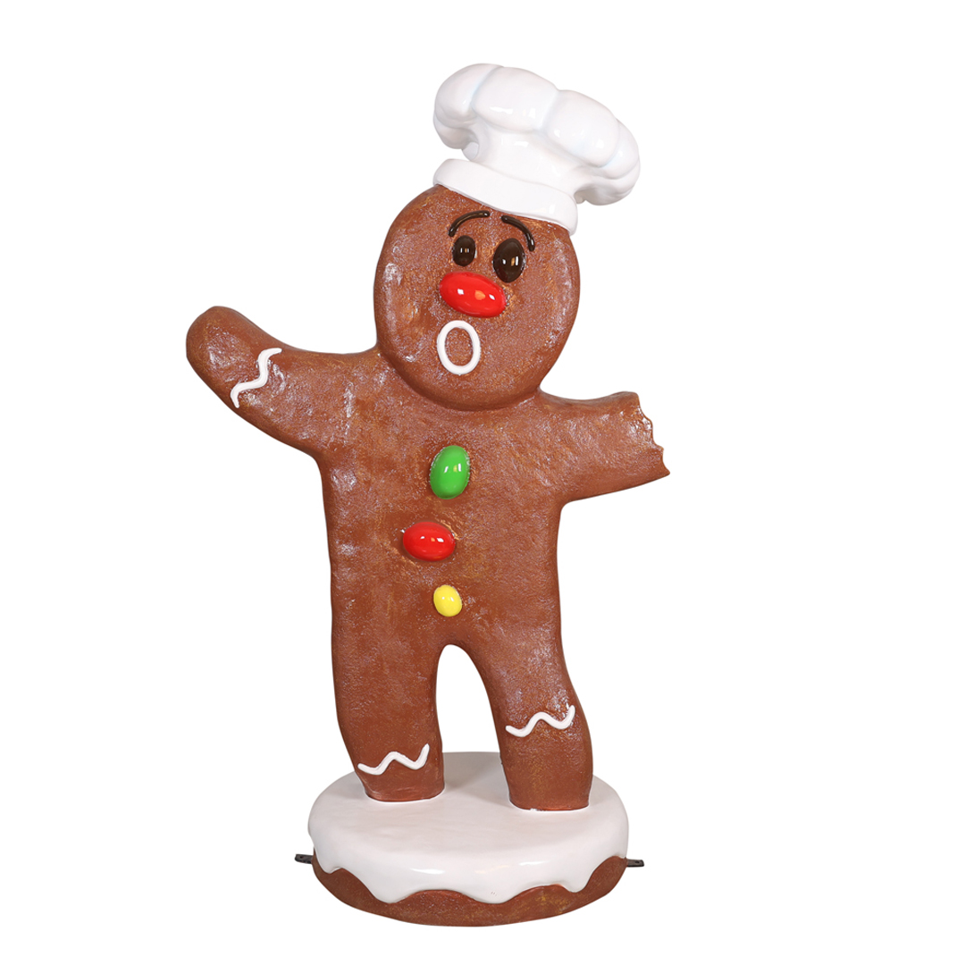 Gingerbread man cookie with a chef hat, colorful buttons, white icing details, and a bite on one arm.